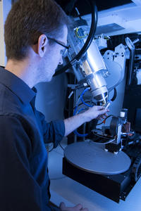 A man stands in front of a machine