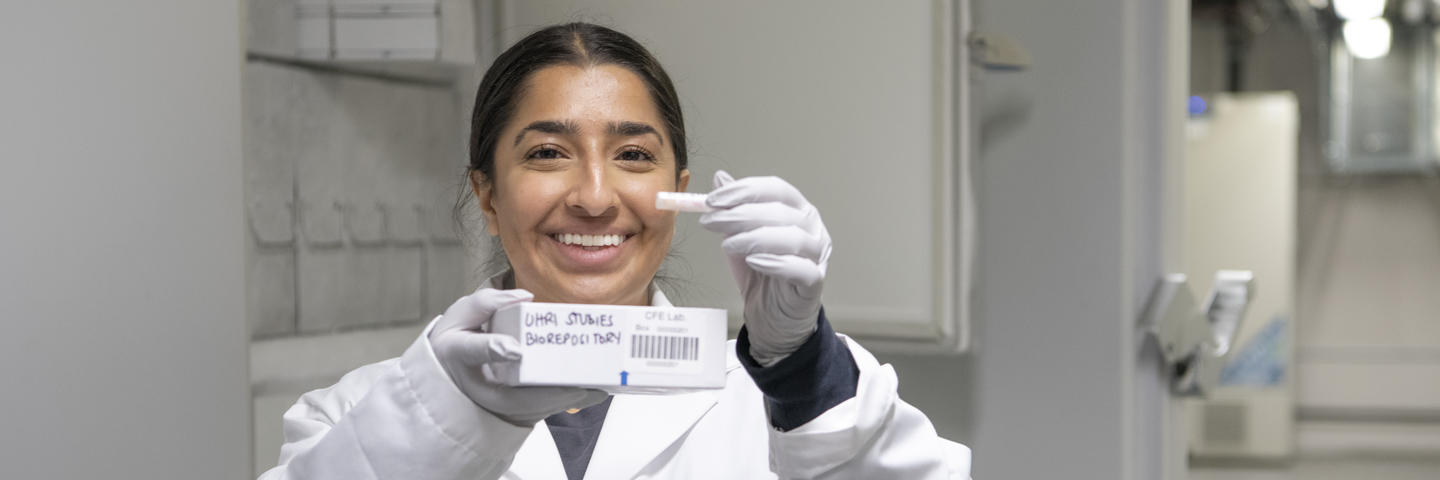 A woman stands with a sample in her hand